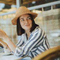 Woman reading a book at a cafe